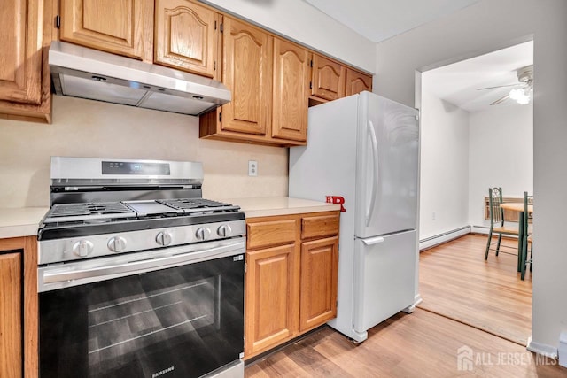 402 N Cranbury Rd Unit 8, East Brunswick, NJ 08816 - kitchen with stainless steel range with gas stovetop, under cabinet range hood, freestanding refrigerator, light countertops, and a ceiling fan