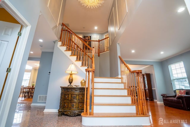 4 Bernadette Cir S, Brunswick, NJ 08852 - stairway featuring plenty of natural light, ornamental molding, baseboards, recessed lighting, and a chandelier