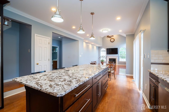 4 Bernadette Cir S, Brunswick, NJ 08852 - kitchen featuring ornamental molding, baseboards, wood finished floors, dark brown cabinets, and pendant lighting