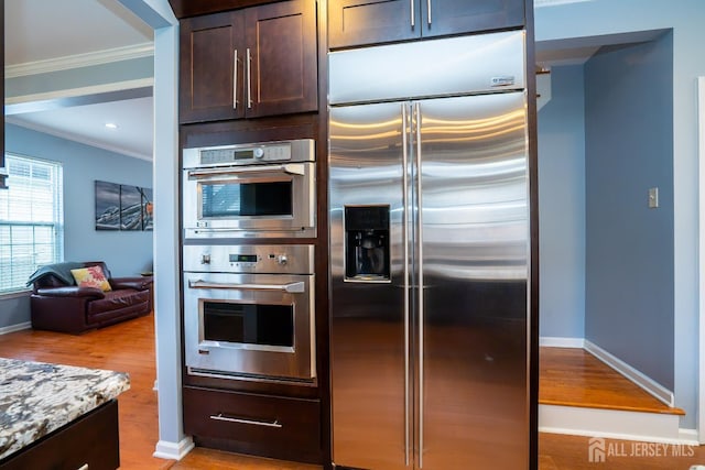 4 Bernadette Cir S, Brunswick, NJ 08852 - kitchen with stainless steel appliances, crown molding, dark brown cabinets, light wood finished floors, and baseboards