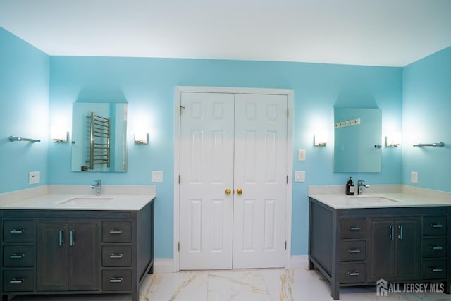 4 Bernadette Cir S, Brunswick, NJ 08852 - bathroom featuring marble finish flooring, two vanities, a towel warmer, and baseboards
