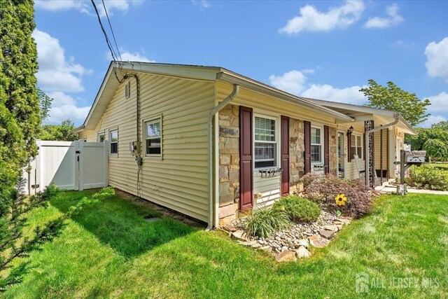 13 Sheffield Ave, Monroe, NJ 08831 - view of side of home with stone siding and a gate