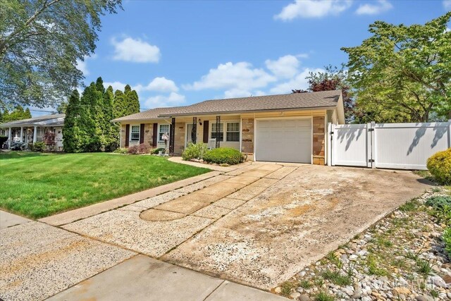 13 Sheffield Ave, Monroe, NJ 08831 - single story home with an attached garage, a gate, and driveway