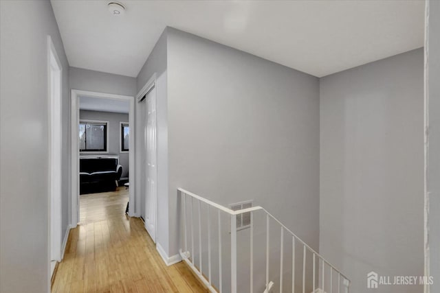 186 Hamilton Pl, East Windsor, NJ 08520 - corridor featuring an upstairs landing, light wood-type flooring, and baseboards