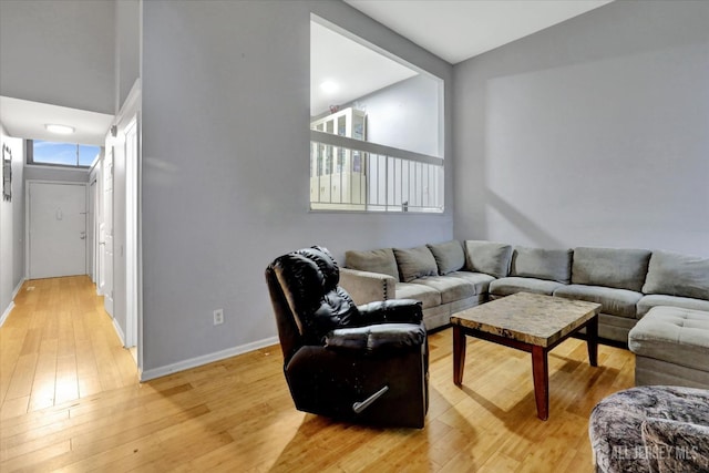 186 Hamilton Pl, East Windsor, NJ 08520 - living area with light wood-style flooring, baseboards, and lofted ceiling