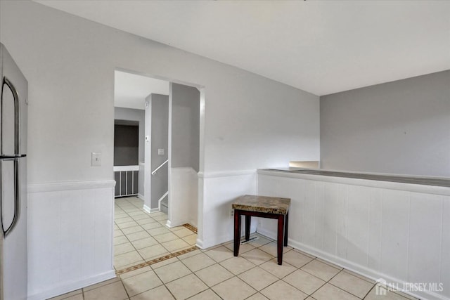 186 Hamilton Pl, East Windsor, NJ 08520 - unfurnished dining area featuring light tile patterned floors and wainscoting