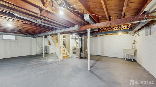 13 Prospect St, Metuchen, NJ 08840 - below grade area with washer / dryer, heating unit, stairs, and a sink