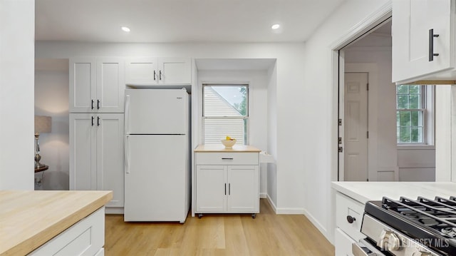 13 Prospect St, Metuchen, NJ 08840 - kitchen with freestanding refrigerator, light wood-type flooring, plenty of natural light, white cabinets, and recessed lighting