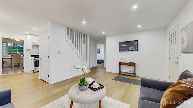 13 Prospect St, Metuchen, NJ 08840 - living room featuring stairway, light wood-style flooring, recessed lighting, and baseboards