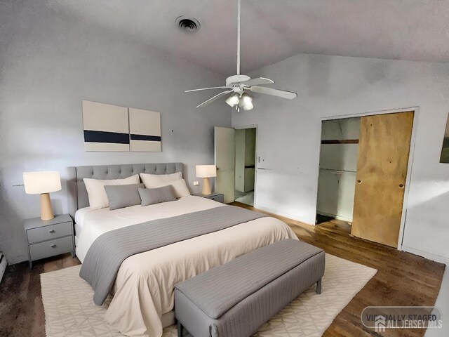 bedroom featuring high vaulted ceiling, hardwood / wood-style floors, ceiling fan, and a closet