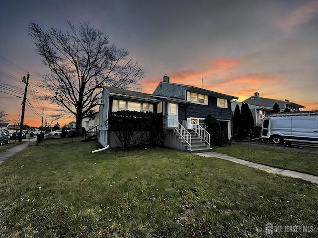 split level home featuring a lawn