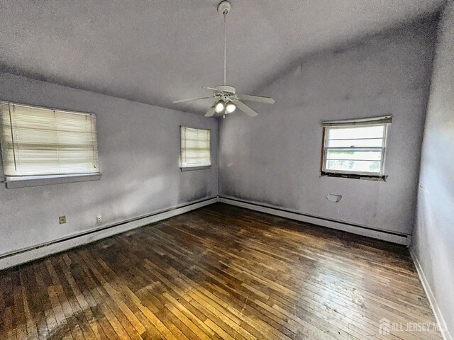 spare room featuring dark wood-type flooring, ceiling fan, and lofted ceiling