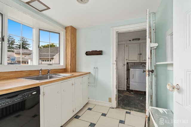 kitchen featuring white cabinets, dishwasher, sink, and washer / clothes dryer