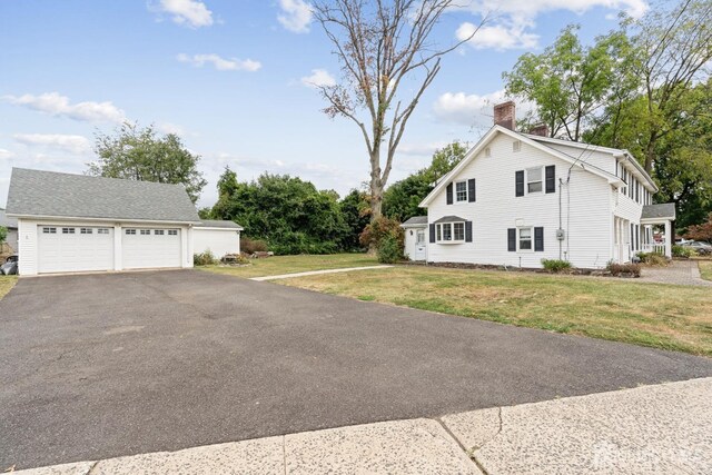 view of home's exterior featuring a garage and a yard