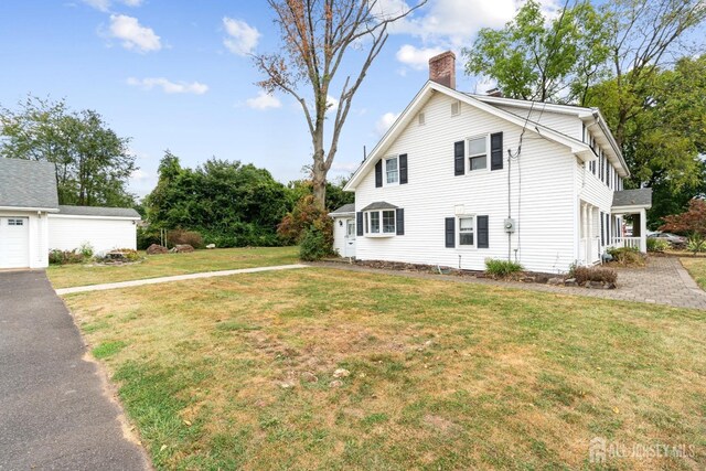 view of side of home featuring a yard