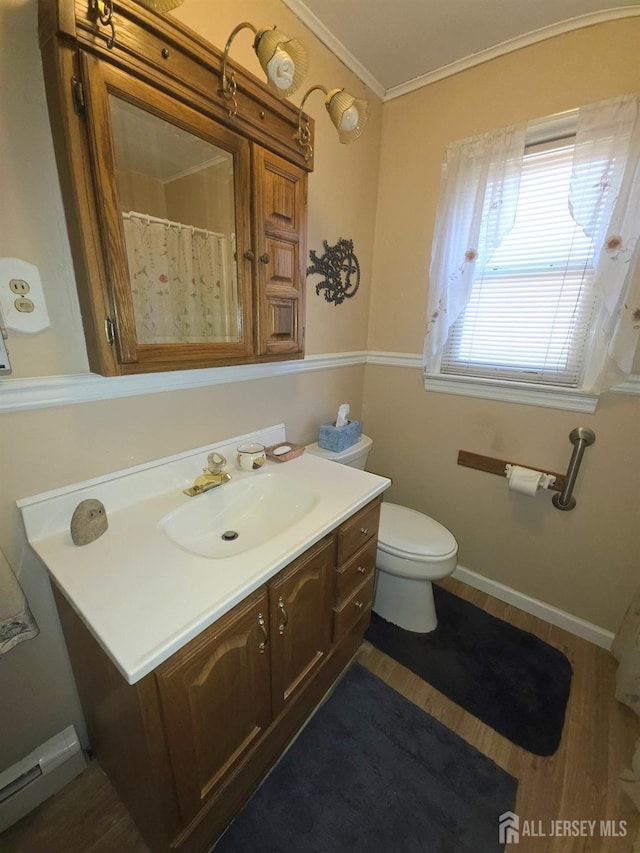 144 Buckelew Ave, Jamesburg, NJ 08831 - bathroom with baseboard heating, vanity, crown molding, and wood finished floors