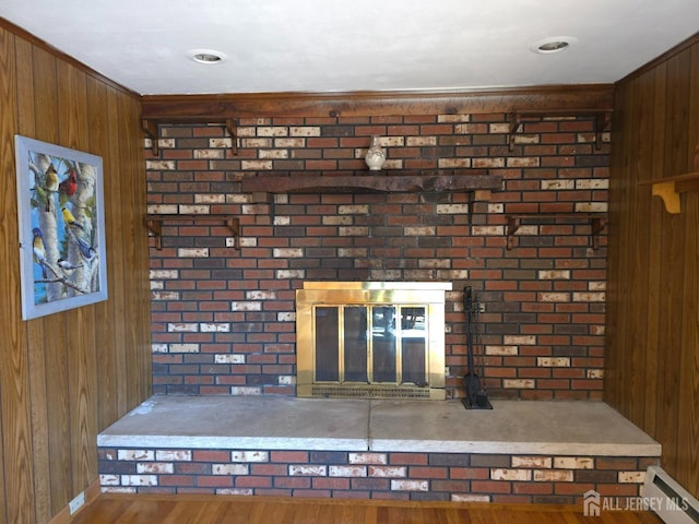 144 Buckelew Ave, Jamesburg, NJ 08831 - detailed view of a baseboard heating unit, wooden walls, wood finished floors, and baseboards