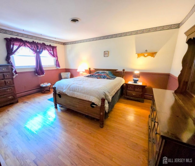 144 Buckelew Ave, Jamesburg, NJ 08831 - bedroom featuring light wood-style floors and a baseboard radiator