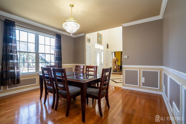 45 Green Ash St, Monroe, NJ 08831 - dining space featuring a chandelier, wood-type flooring, ornamental molding, and a wainscoted wall