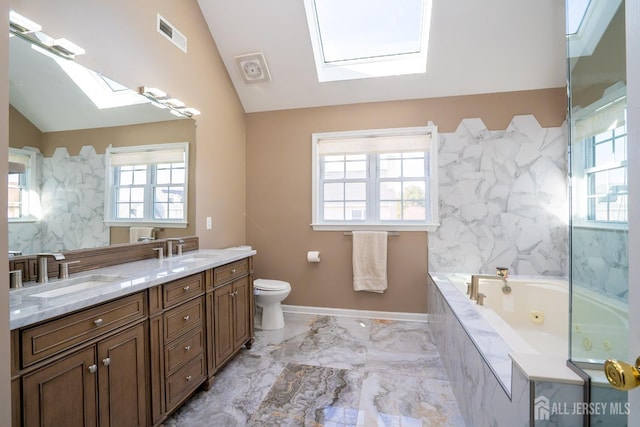 45 Green Ash St, Monroe, NJ 08831 - full bath featuring a skylight, vaulted ceiling, healthy amount of natural light, a whirlpool tub, and double vanity