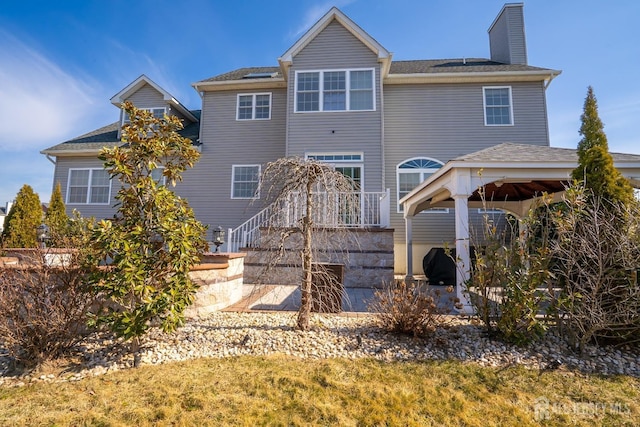 45 Green Ash St, Monroe, NJ 08831 - rear view of house featuring a chimney, a gazebo, roof with shingles, and stairway