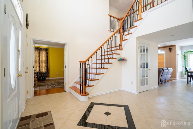 45 Green Ash St, Monroe, NJ 08831 - foyer with a high ceiling, stairs, tile patterned floors, and baseboards