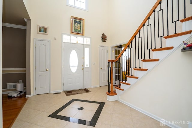 45 Green Ash St, Monroe, NJ 08831 - tiled entrance foyer featuring a high ceiling, baseboards, stairs, and ornamental molding
