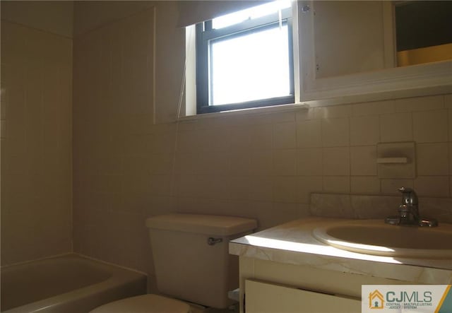 full bathroom with shower / bathtub combination, vanity, and toilet