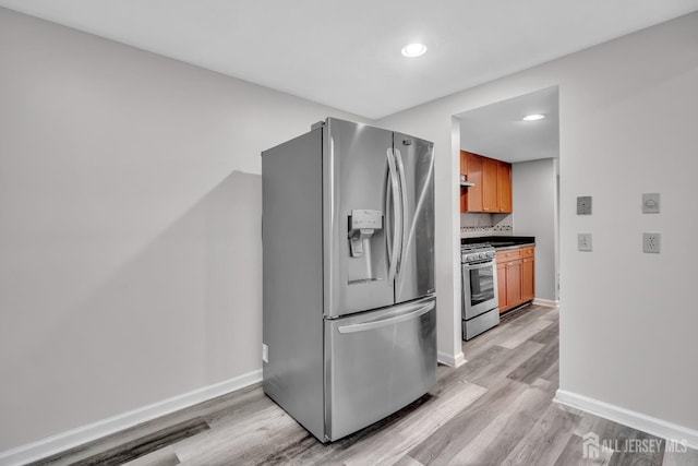 73 Doe Ct, South Brunswick, NJ 08852 - kitchen with appliances with stainless steel finishes, light wood-type flooring, baseboards, brown cabinets, and recessed lighting