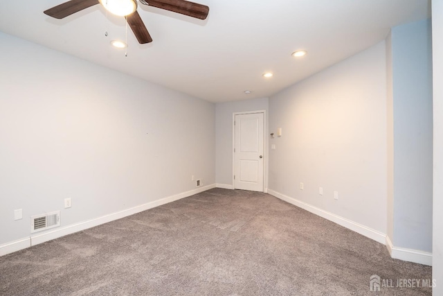 spare room with carpet floors and ceiling fan