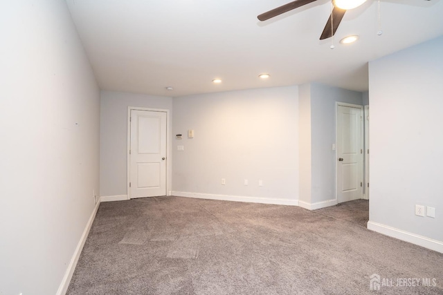 empty room featuring ceiling fan, carpet floors, recessed lighting, and baseboards