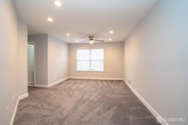 spare room with recessed lighting, carpet, and baseboards