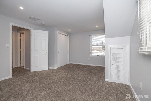 unfurnished bedroom with lofted ceiling and carpet floors