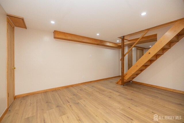 basement with light hardwood / wood-style flooring