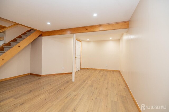 basement with hardwood / wood-style floors