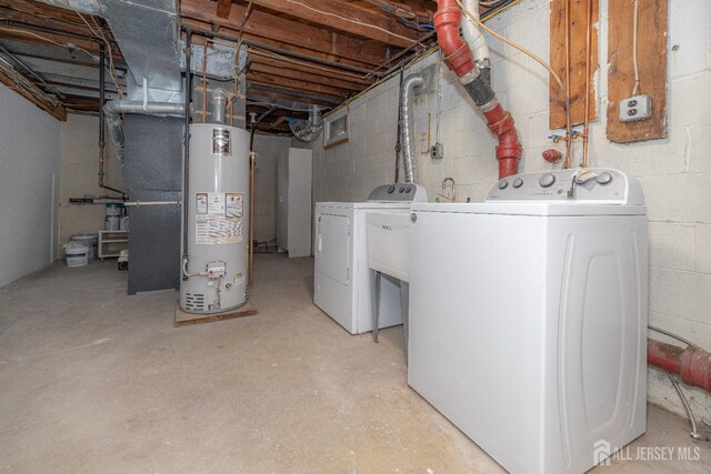 basement featuring washing machine and dryer and water heater