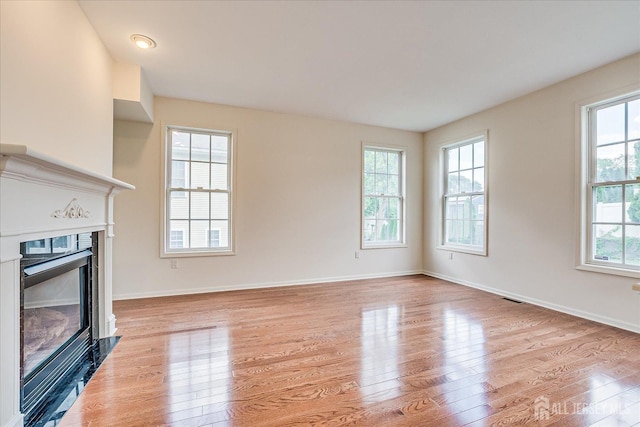 15 Fabiszewski Way, Parlin, NJ 08859 - unfurnished living room with a glass covered fireplace, light wood-type flooring, and baseboards
