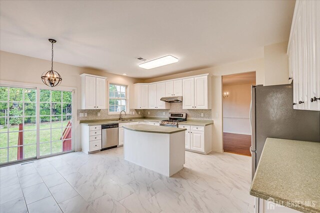 15 Fabiszewski Way, Parlin, NJ 08859 - kitchen featuring stainless steel appliances, under cabinet range hood, a sink, white cabinetry, and tasteful backsplash