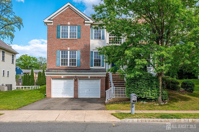 15 Fabiszewski Way, Parlin, NJ 08859 - view of front facade with brick siding, asphalt driveway, a garage, and stairs