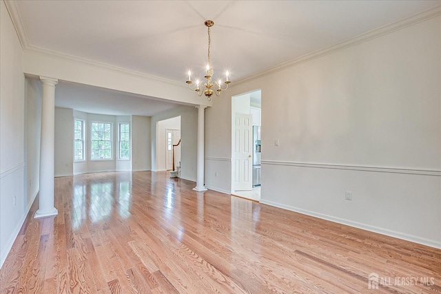 15 Fabiszewski Way, Parlin, NJ 08859 - spare room featuring ornate columns, a chandelier, crown molding, light wood-type flooring, and baseboards