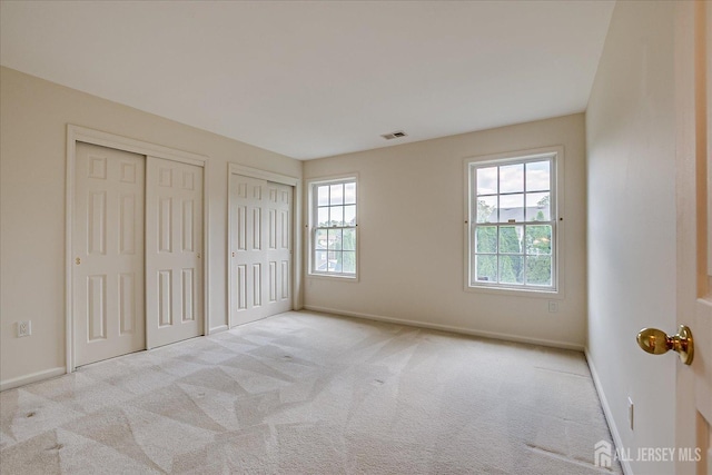 15 Fabiszewski Way, Parlin, NJ 08859 - unfurnished bedroom with multiple closets, multiple windows, and carpet floors