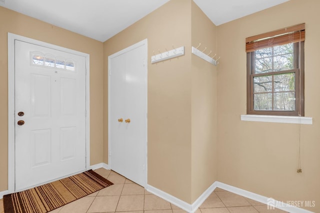 foyer entrance with baseboards and light tile patterned floors