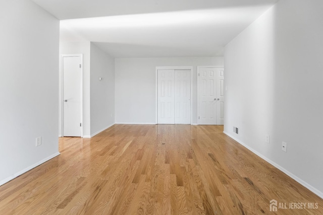 interior space with light wood-style flooring and baseboards