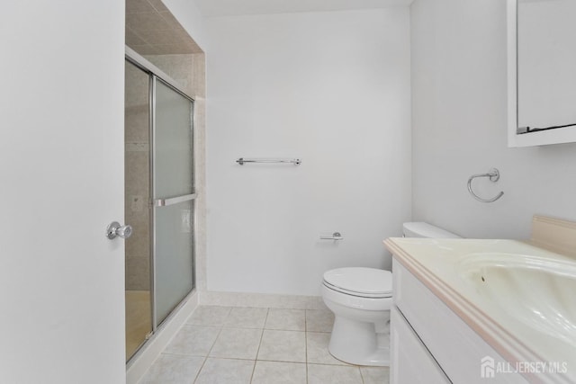 full bathroom with a stall shower, vanity, toilet, and tile patterned flooring