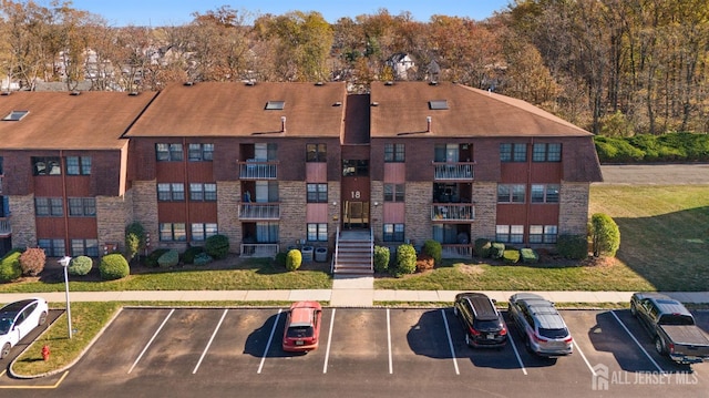 view of building exterior with uncovered parking