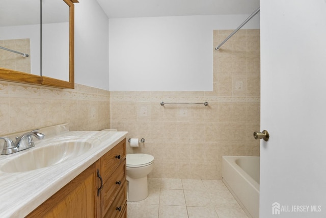 full bath with vanity, tile walls, toilet, tile patterned floors, and bathing tub / shower combination