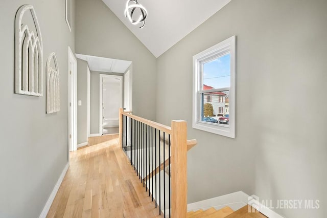 15 Clausen Ln, Sayreville, NJ 08872 - corridor featuring an upstairs landing, attic access, light wood finished floors, and lofted ceiling