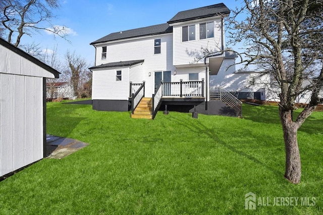 15 Clausen Ln, Sayreville, NJ 08872 - rear view of property featuring a lawn and a wooden deck
