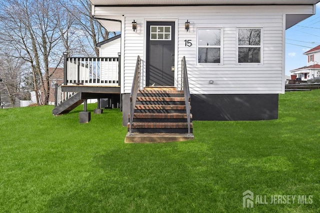 15 Clausen Ln, Sayreville, NJ 08872 - back of property featuring a lawn, a wooden deck, and stairway