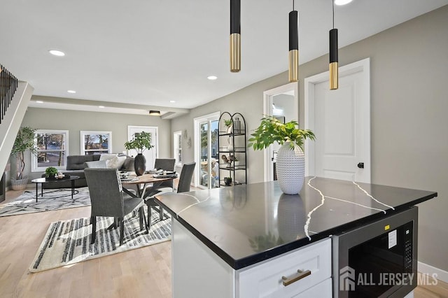 15 Clausen Ln, Sayreville, NJ 08872 - kitchen with dark countertops, white cabinets, light wood-style floors, open floor plan, and recessed lighting